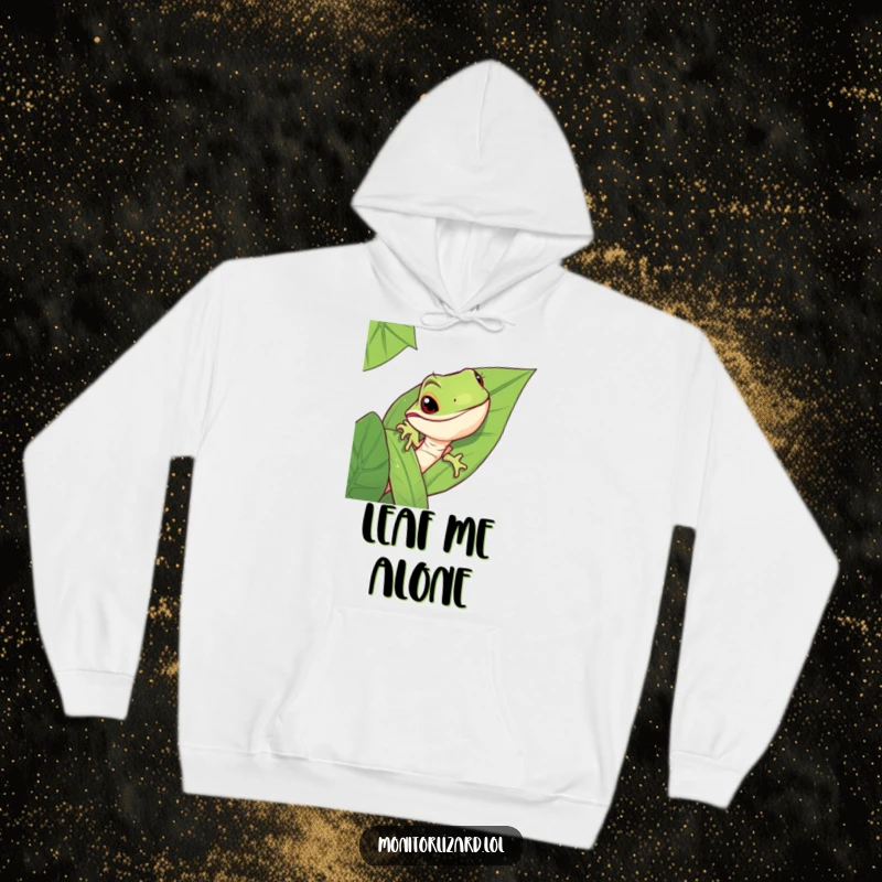 Funny monitor lizard hoodie with a mischievous lizard peeking from behind a large jungle leaf, offering warmth and style.