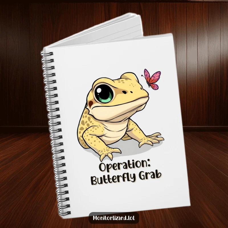 Funny notebook featuring a monitor lizard with big eyes, hilariously trying to catch a butterfly. Ideal for note-taking.